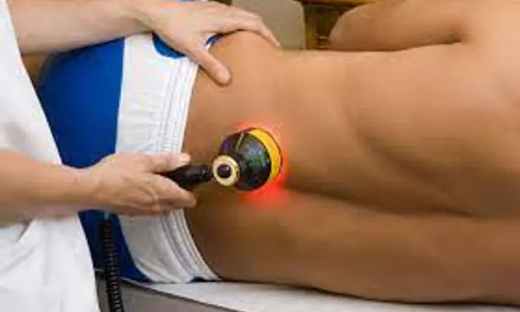Low level laser therapy being applied to a patient's lower back