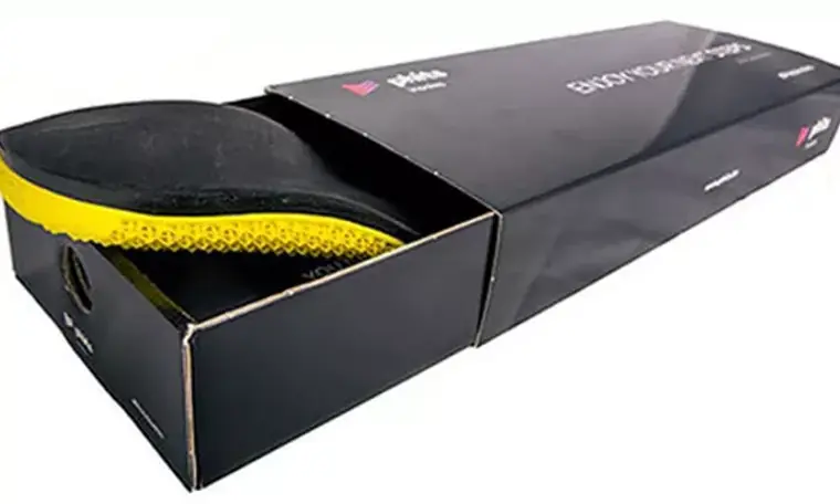 A pair of PHITs 3D-printed custom orthotic insoles in their box